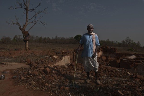 Jeetlal Baiga in the Sasan Moher block forest area, stands near his broken down home, from where his family was displaced by the Sasan coal mine project