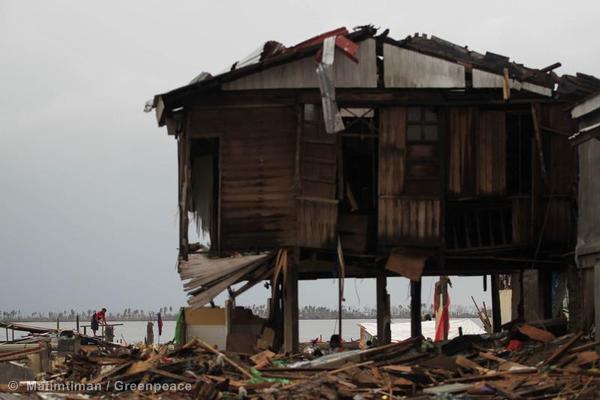 A man looks for salvageable items from buildings destroyed by Typhoon Haiyan